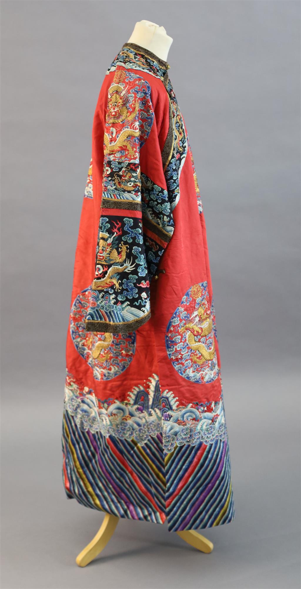 A Chinese red satin dragon winter robe, late Qing dynasty, length 129cm